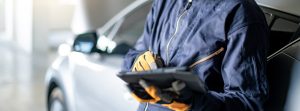 Mechanic,Holding,Digital,Tablet,Checking,Car,In,Garage | Lanham, MD