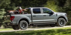 a gray 2024 Ford F-150 with 2 motorbike in the truck bed | Lanham, MD 